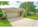 Single-story home boasts an attached garage, blue door, and well-maintained landscaping at 413 Pursley Dr, Deland, FL 32724
