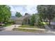 Charming single-story home with a stone facade, lush landscaping, and a two-car garage at 413 Pursley Dr, Deland, FL 32724