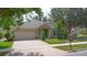Attractive home with a stone-accented entrance, manicured lawn, and an attached two-car garage at 413 Pursley Dr, Deland, FL 32724