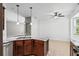 Updated kitchen features stainless appliances, granite counters, pendant lights, and wood cabinets at 413 Pursley Dr, Deland, FL 32724