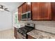 Updated kitchen offers a gas range, stainless steel appliances, granite counters and subway tile at 413 Pursley Dr, Deland, FL 32724
