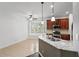 Bright kitchen with stainless appliances, tile floors, granite countertops, and view from a bay window at 413 Pursley Dr, Deland, FL 32724