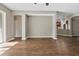 Open-concept living room with wood flooring, archway details, neutral colors, and lots of natural light at 413 Pursley Dr, Deland, FL 32724