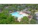 Aerial view of the community swimming pool with water features, seating areas, and lush landscaping at 413 Pursley Dr, Deland, FL 32724