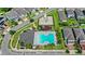 Aerial view of neighborhood, highlighting a large community pool, playground, and well-maintained homes at 4301 Creek Bank Dr, Kissimmee, FL 34744