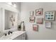 Well-lit bathroom with a large mirror and decorative wall art at 4301 Creek Bank Dr, Kissimmee, FL 34744