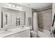 This updated bathroom features a dual vanity and modern fixtures at 4301 Creek Bank Dr, Kissimmee, FL 34744