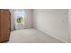 Bright bedroom with plush carpeting and natural light from the large window at 4301 Creek Bank Dr, Kissimmee, FL 34744