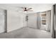 Carpeted bedroom with a ceiling fan, window, and closet at 4301 Creek Bank Dr, Kissimmee, FL 34744