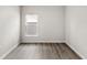 Bright bedroom with sleek floors and a large window at 4301 Creek Bank Dr, Kissimmee, FL 34744