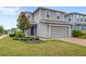 Charming two-story home featuring a well-maintained lawn, landscaping and brick-paved driveway at 4301 Creek Bank Dr, Kissimmee, FL 34744