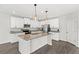 Spacious kitchen with an island, stainless steel appliances, and modern lighting at 4301 Creek Bank Dr, Kissimmee, FL 34744