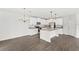 Bright kitchen boasts granite counters, an island, stainless appliances, and elegant pendant lighting at 4301 Creek Bank Dr, Kissimmee, FL 34744