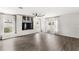 Spacious living room with wood floors, large windows, and built-in shelving at 4301 Creek Bank Dr, Kissimmee, FL 34744
