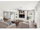 Staged living room with built-in shelving, hardwood floors, and ample natural light at 4301 Creek Bank Dr, Kissimmee, FL 34744