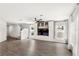 Bright living room featuring hardwood floors, built-in shelving, and large windows at 4301 Creek Bank Dr, Kissimmee, FL 34744