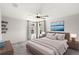 Staged main bedroom with ceiling fan, windows, and stylish decor at 4301 Creek Bank Dr, Kissimmee, FL 34744