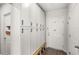 Mud room with white storage cabinets, bench, and access to the front door at 4301 Creek Bank Dr, Kissimmee, FL 34744