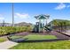 Community playground with slides and play equipment, featuring a padded ground surface for safety at 4301 Creek Bank Dr, Kissimmee, FL 34744