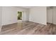Bedroom with wood-look flooring, a ceiling fan and a sliding door to the lanai at 435 Boxwood Cir, Winter Springs, FL 32708
