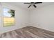 Bright bedroom with wood-look flooring, large window, and neutral paint at 435 Boxwood Cir, Winter Springs, FL 32708