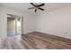 Bedroom featuring wood-look flooring, a ceiling fan and a glass sliding door to the lanai at 435 Boxwood Cir, Winter Springs, FL 32708