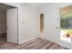 Welcoming entryway with wood-look flooring and a storm door with sidelight at 435 Boxwood Cir, Winter Springs, FL 32708