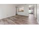Bright living area with wood-look floors and a sliding door to the lanai at 435 Boxwood Cir, Winter Springs, FL 32708