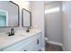 Modern bathroom featuring double vanity with white countertop, black faucets and hardware, and a sleek design at 4409 W Gore Ave, Orlando, FL 32811