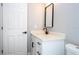 Clean bathroom featuring a white vanity with black hardware, a modern sink, and a stylish mirror at 4409 W Gore Ave, Orlando, FL 32811