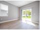Light filled room with sliding glass door leading to the backyard and an additional window at 4409 W Gore Ave, Orlando, FL 32811