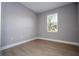 Cozy bedroom with natural light from a window, light gray walls and neutral flooring creating a peaceful retreat at 4409 W Gore Ave, Orlando, FL 32811