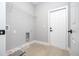 Functional laundry room with shelving and hookups, offering convenience and practicality at 4409 W Gore Ave, Orlando, FL 32811