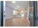Bright, open-concept living area with wood-look floors, modern lighting, and an open flow to the kitchen at 4409 W Gore Ave, Orlando, FL 32811