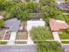 Aerial view of home with a pool, new roof, and surrounded by mature trees at 452 Sundown Trl, Casselberry, FL 32707