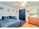 Inviting bedroom featuring a ceiling fan, wood dresser, and playful decorative accents at 452 Sundown Trl, Casselberry, FL 32707