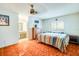 Cozy bedroom with colorful striped bedspread, ceiling fan, and access to a vanity area at 452 Sundown Trl, Casselberry, FL 32707