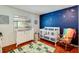 Charming Bedroom with crib, changing table and a cozy rocking chair at 452 Sundown Trl, Casselberry, FL 32707