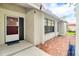 Home entrance with a brick-paved patio, covered entry, and view of side of home at 452 Sundown Trl, Casselberry, FL 32707