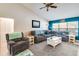 Comfortable living room featuring a vaulted ceiling, plush seating, and neutral paint colors at 452 Sundown Trl, Casselberry, FL 32707