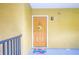 Welcoming yellow door adorned with a wreath and a cheerful doormat, inviting you to come inside at 5259 Images Cir # 301, Kissimmee, FL 34746