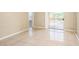 Living room featuring bright tile flooring, neutral paint and sliding glass doors that brings in plenty of natural light at 5259 Images Cir # 301, Kissimmee, FL 34746