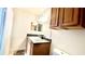 Bathroom with vanity, framed mirror, wood cabinets, and a white toilet at 5500 Devonbriar Way # 202, Orlando, FL 32822