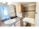Full bathroom with tiled shower-tub combination, framed mirror, and wood vanity at 5500 Devonbriar Way # 202, Orlando, FL 32822