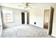 Bedroom with neutral paint, carpet, ceiling fan, window, and closet at 5500 Devonbriar Way # 202, Orlando, FL 32822