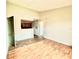Living area showcasing hardwood floors, adjacent kitchen with dark cabinets, and neutral paint at 5500 Devonbriar Way # 202, Orlando, FL 32822