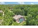 Aerial view of beautiful home and pool enclosed by screened lanai and mature landscaping at 621 Estates Pl, Longwood, FL 32779