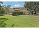 Expansive backyard with lush green lawn and screened in enclosure at 621 Estates Pl, Longwood, FL 32779