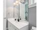 Bright bathroom featuring a large mirror, white vanity with storage, and light gray wall paint at 621 Estates Pl, Longwood, FL 32779