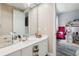 Bathroom vanity with a large mirror and white cabinets, offering ample storage space and a clean, bright aesthetic at 621 Estates Pl, Longwood, FL 32779